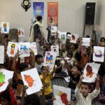 Sunday School Children showing coloring activity sheets