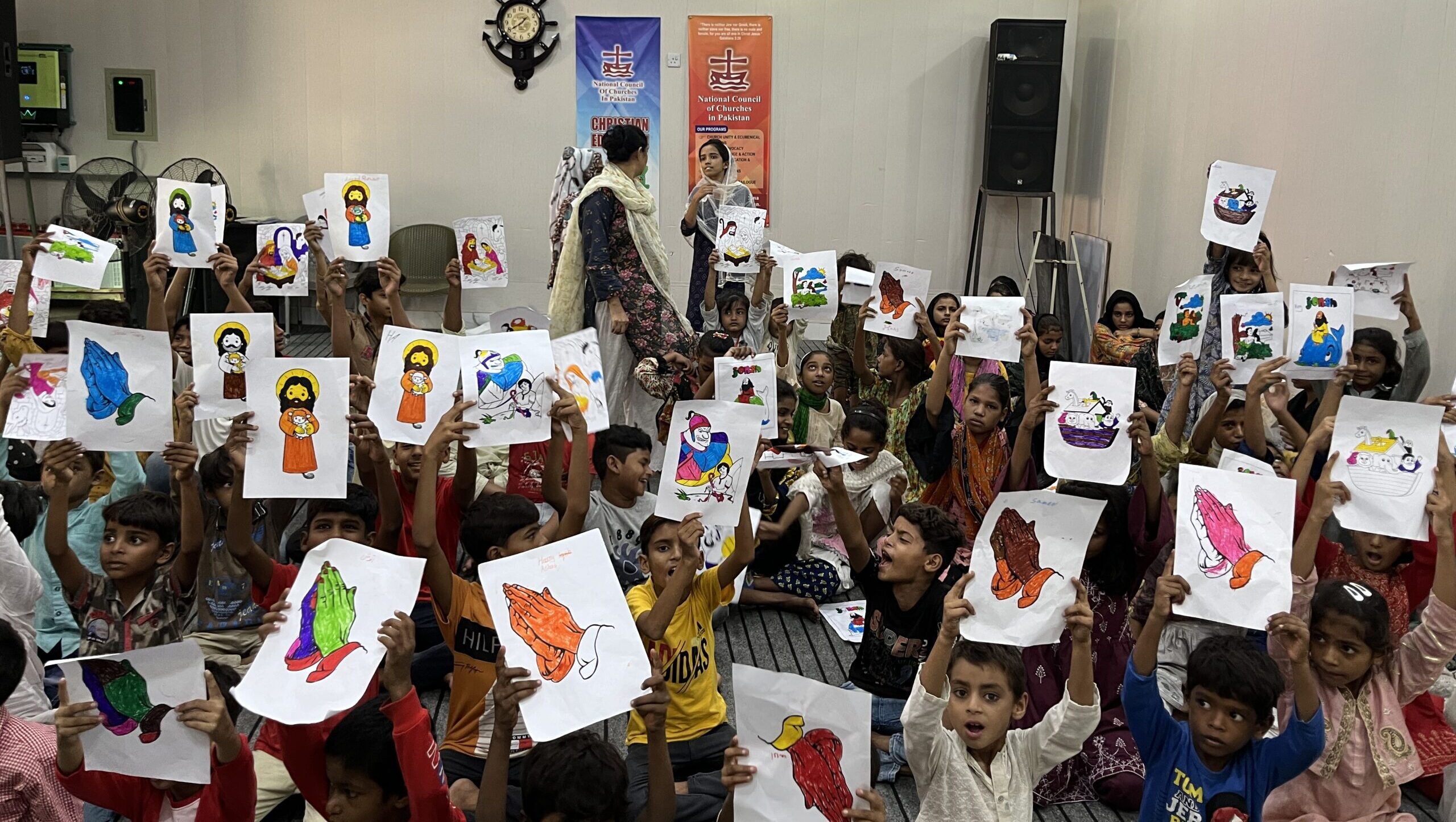 Sunday School Children showing coloring activity sheets